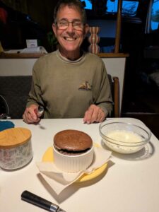 Mike with chocolate souffle baked onboard